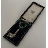 A cased Victorian silver key on velvet mount. Appr