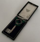 A cased Victorian silver key on velvet mount. Appr