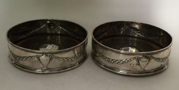 A good pair of Georgian silver wine coasters with