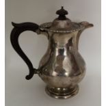 A silver hot water jug with reeded border. Birming