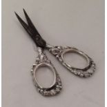 A pair of silver mounted embossed scissors with st