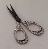 A pair of silver mounted embossed scissors with st