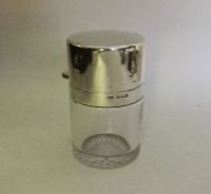 A silver and glass hinged top scent bottle. Birmin