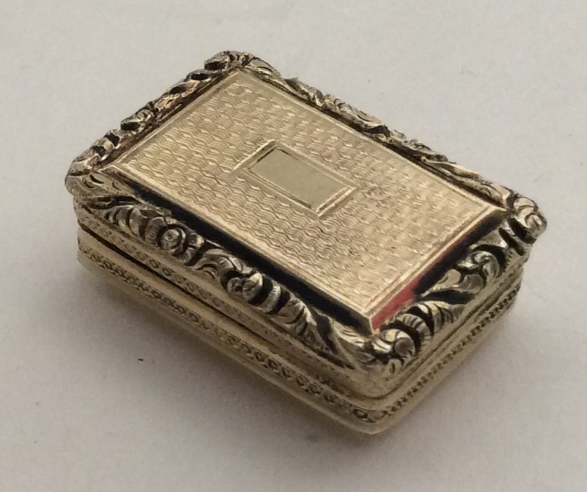A silver gilt rectangular cast vinaigrette. London