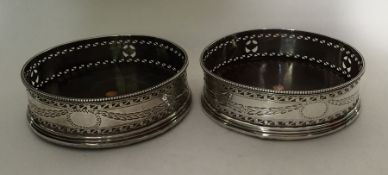 A pair of Continental silver wine coasters with sw