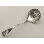 A good quality silver sifter spoon with fluted bow