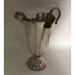 A large Italian silver ewer on spreading support.