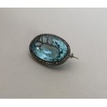 A large oval aquamarine and rose diamond brooch in