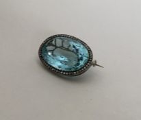 A large oval aquamarine and rose diamond brooch in