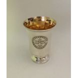A tapering silver chalice with gilt interior. Lond