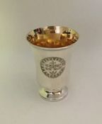 A tapering silver chalice with gilt interior. Lond