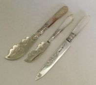 Two attractively engraved silver butter knives wit