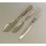 Two attractively engraved silver butter knives wit