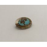 MURRLE BENNETT: An oval turquoise brooch with reed