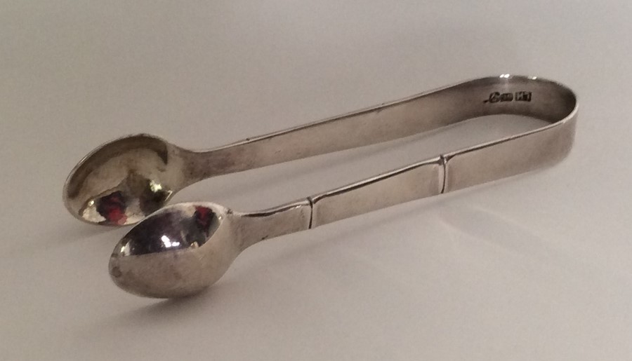 A pair of Chinese silver sugar tongs of typical de