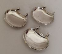 An unusual set of three silver saucer dishes with