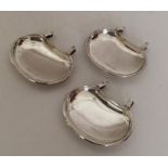 An unusual set of three silver saucer dishes with