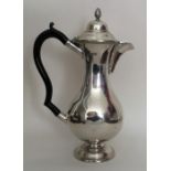 A slender silver hot water jug with gadroon rim. L