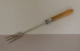 A silver and ivory mounted pickle fork with twiste