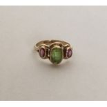 A peridot mounted three stone ring in 9 carat sett