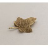 A 9 carat brooch in the form of a leaf. Approx. 3.