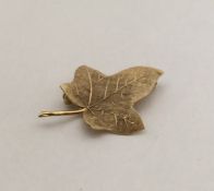 A 9 carat brooch in the form of a leaf. Approx. 3.