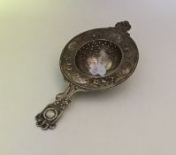 A Continental silver tea strainer with pierced dec