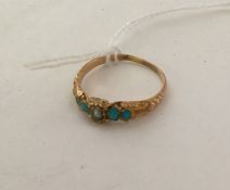 A turquoise and pearl ring with chased decoration.