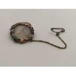 A stylish oval gold and rose diamond brooch mounte