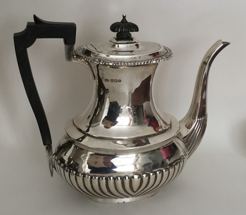 A large silver half fluted coffee pot with gadroon