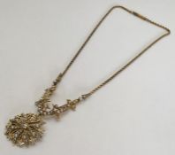 An Edwardian 15 carat gold pendant set with half p