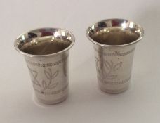 A pair of silver Kiddish cups of tapering forms. A