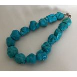 A heavy tapering string of turquoise beads. Approx