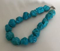 A heavy tapering string of turquoise beads. Approx