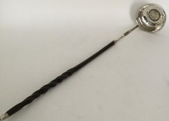 A Georgian silver toddy ladle with central coin to