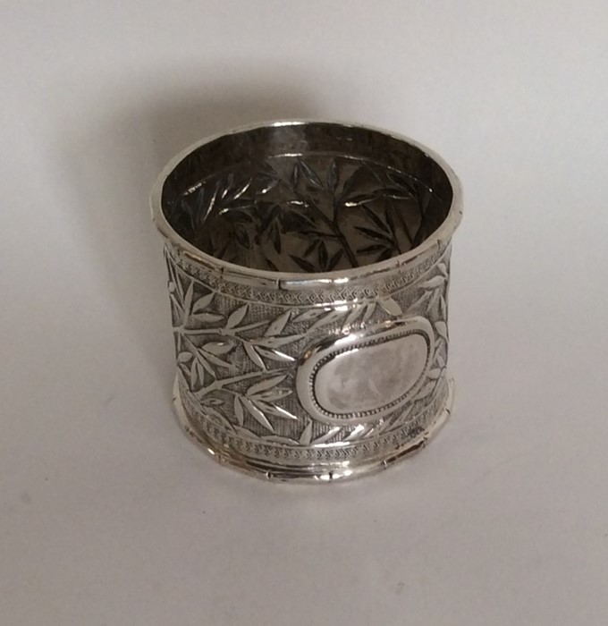 A Chinese silver napkin ring decorated with bamboo