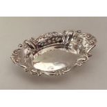 An oval boat shaped silver bonbon dish with pierce