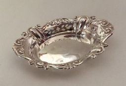 An oval boat shaped silver bonbon dish with pierce