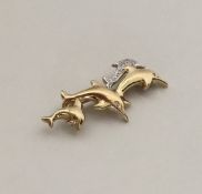 A 9 carat brooch in the form of dolphins with diam