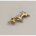 A 9 carat brooch in the form of dolphins with diam