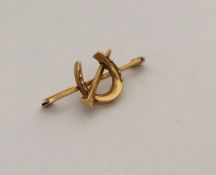 An Antique gold brooch in the form of a horseshoe