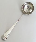 A large silver soup ladle with crested terminal. L