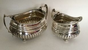 A good Georgian silver half fluted cream and sugar