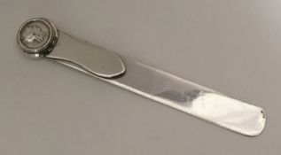 An Edwardian silver letter opener inset with coin.