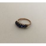 A good sapphire five stone tapering half hoop ring