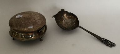 An Edwardian silver tea strainer with pierced bowl
