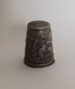 An unusual large chased silver thimble. Approx. 8