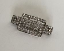 A good Art Deco platinum set brooch decorated in G