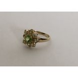 A 9 carat peridot cluster ring in claw mount. Appr