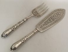 A pair of Victorian silver fish servers with pierc